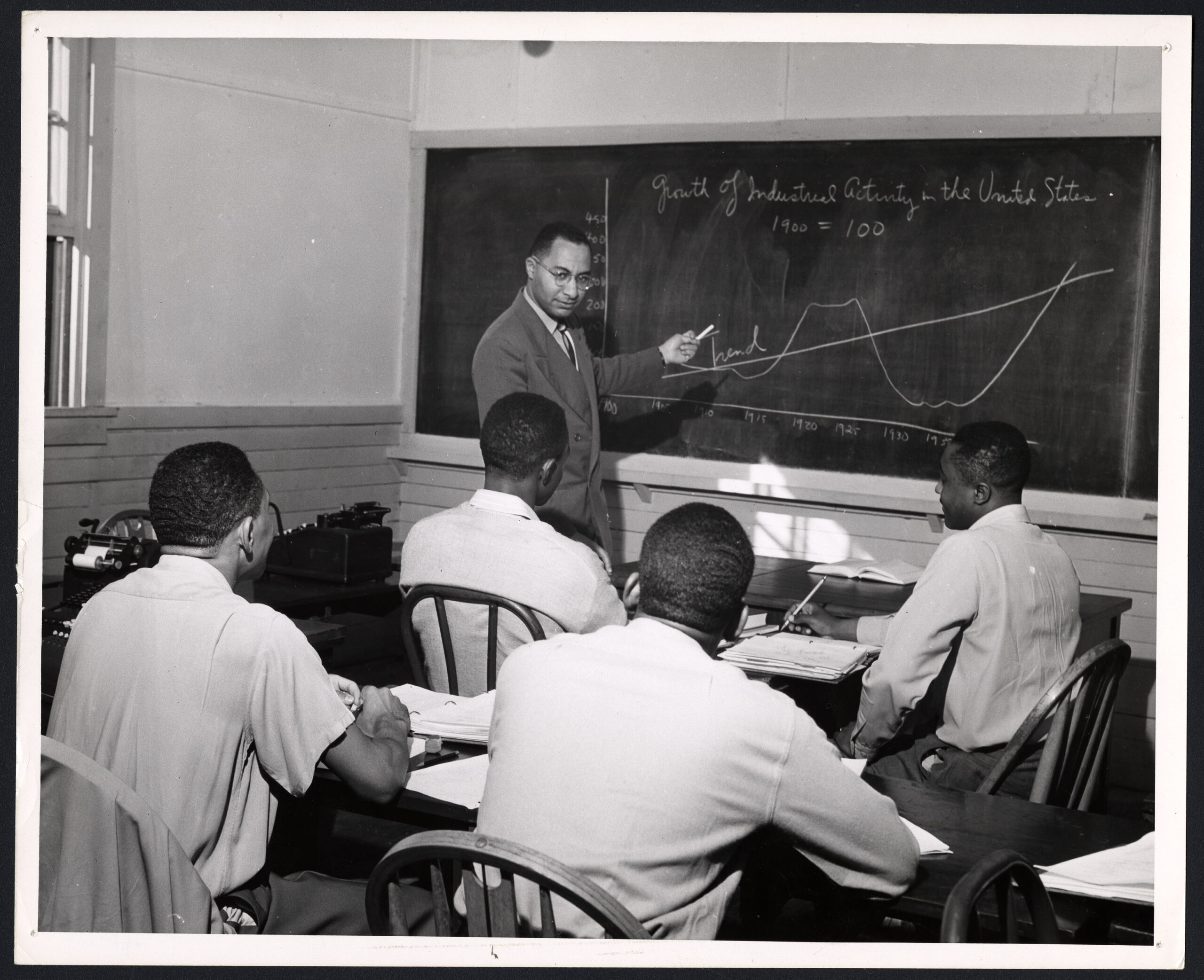 A Group of Men Sitting at a Table, circa 1955